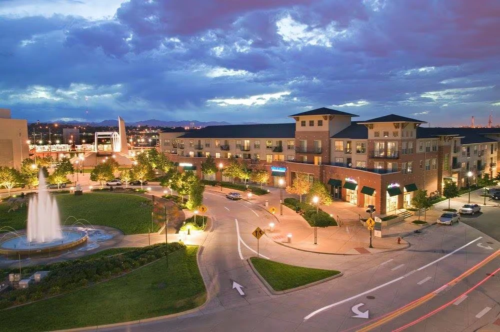 City center with modern architecture and illuminated fountain during evening