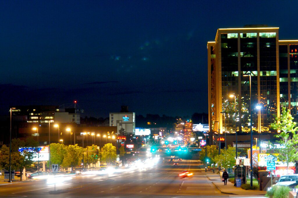 Night cityscape of Glendale, Colorado featuring illuminated streets and tall buildings