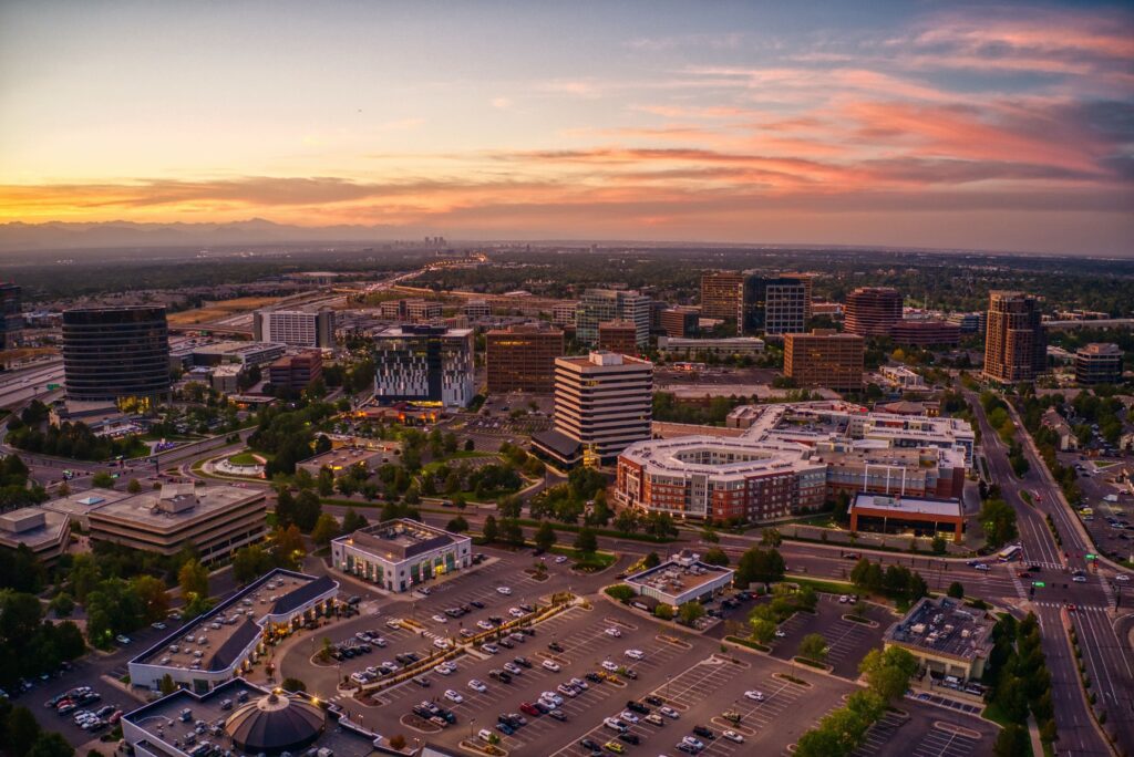 Aerial view of Greenwood Village, Colorado at sunset with a colorful sky and buildings