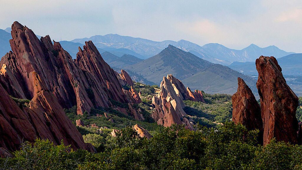 Panoramic view of Roxborough State Park with distinctive red rock formations and distant mountain range