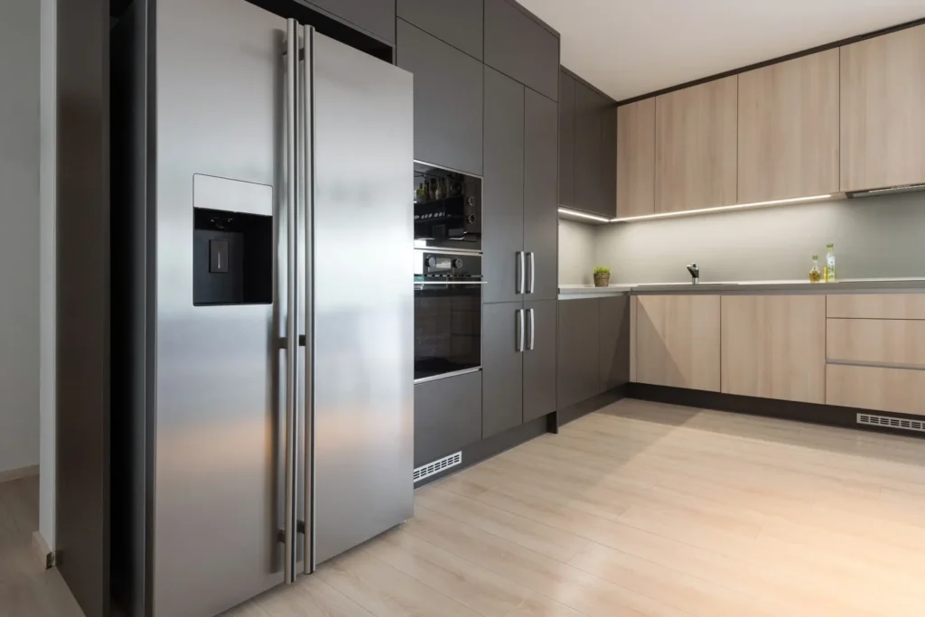 Modern kitchen with stainless steel refrigerator and built-in appliances