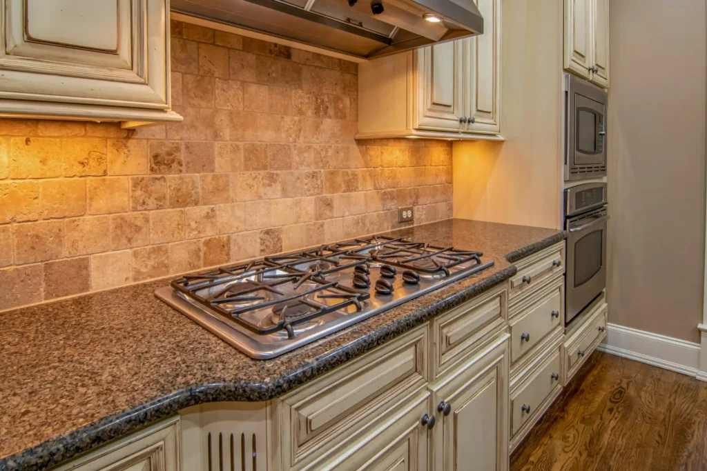 Modern kitchen with granite countertops, a gas stove, and wood cabinetry